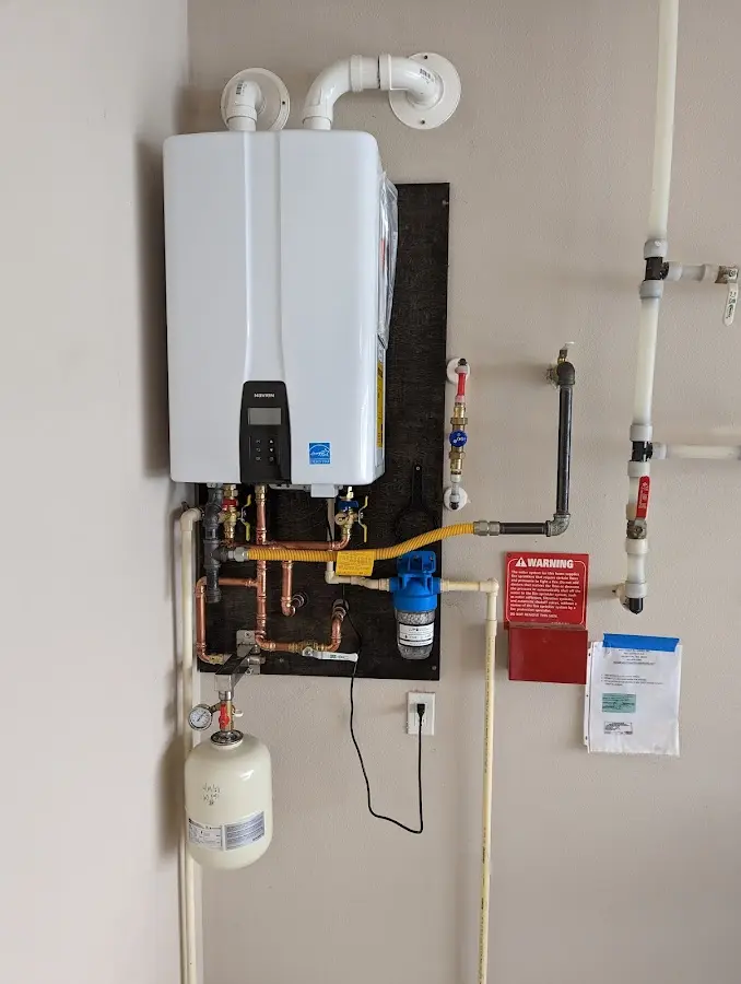 Professional plumber installing copper piping in a Douglasville home